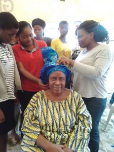 Empowerment Pictures - tying of gele at Christ Orphange Home